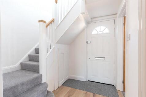 Bright and tidy hallway with a clean white fron...