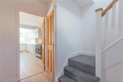 Bright and clean hallway featuring soft carpeti...