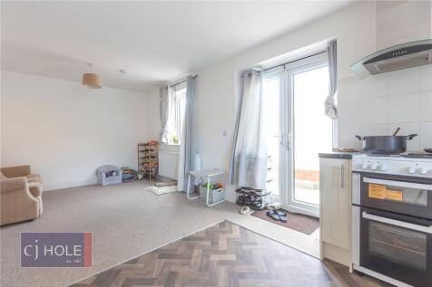Bright and airy living room featuring large win...