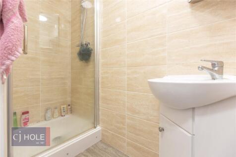 A modern bathroom suite featuring a clean white...