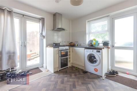 Bright and tidy kitchen featuring modern applia...