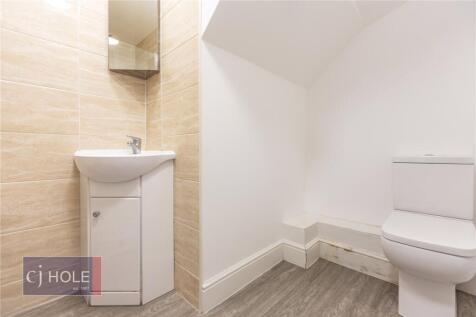 A clean and modern single toilet room featuring...