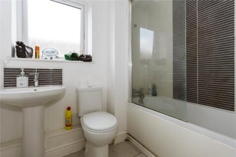 A bright and clean bathroom suite featuring a w...