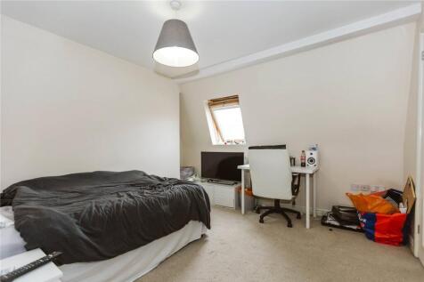 A bright double bedroom featuring a comfortable...