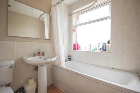 A bright and clean bathroom featuring a full-si...