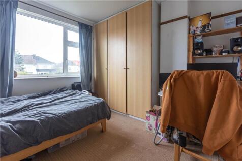 Cozy single bedroom featuring a large window al...