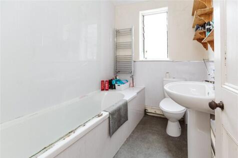 A modern bathroom featuring a bathtub with a to...
