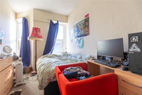 Cozy single bedroom featuring a comfortable bed...