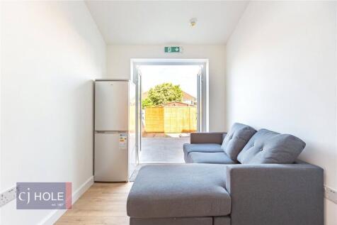 A bright and tidy compact living room featuring...
