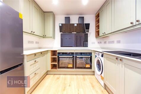 Bright and modern kitchen featuring ample cabin...