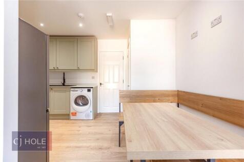 Bright and tidy kitchen area with modern wooden...