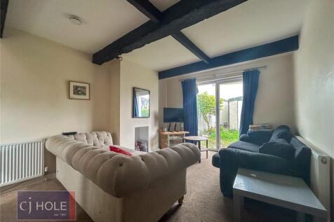 A cozy living room featuring comfortable sofas,...
