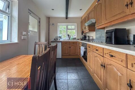 Bright and inviting kitchen featuring natural l...