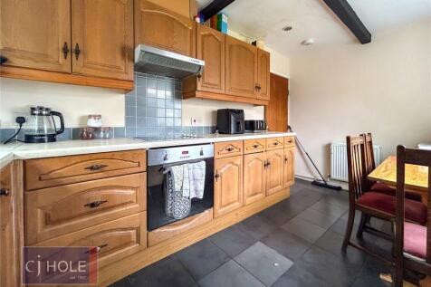 Bright and inviting kitchen space featuring woo...