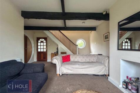 A cozy living room featuring a comfortable sofa...