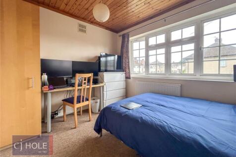 A cozy single bedroom with a large window allow...