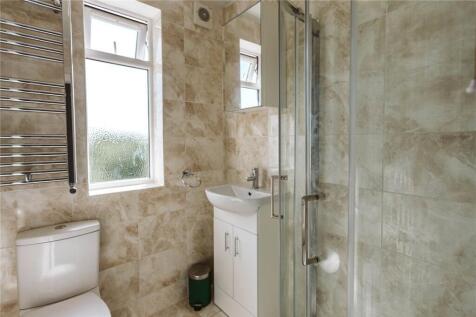 Bright and modern bathroom suite featuring a la...