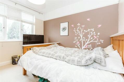 A bright and cozy double bedroom featuring a la...