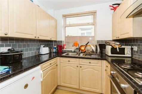 Bright and functional kitchen featuring light w...
