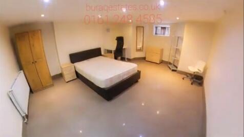 A spacious master bedroom featuring a double be...