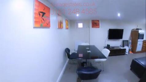 A modern communal lounge featuring a sleek blac...