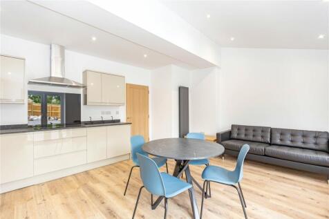 Bright and modern living room featuring a sleek...