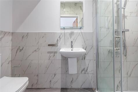Bright and modern bathroom suite featuring eleg...