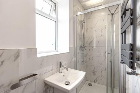 A modern and pristine bathroom suite featuring ...
