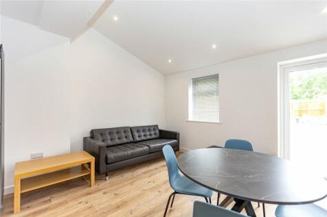 Bright and tidy living room featuring modern fu...