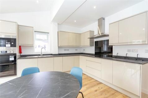 Bright and modern kitchen featuring sleek cream...