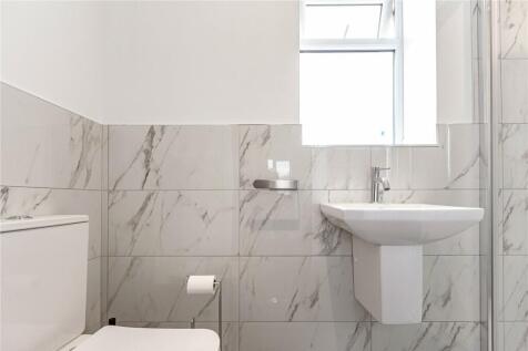 A bright and clean bathroom featuring modern wh...