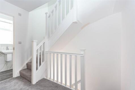 Bright and clean staircase area with fresh whit...