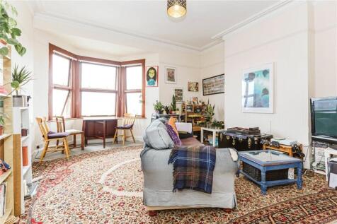 A spacious and bright living room featuring a l...