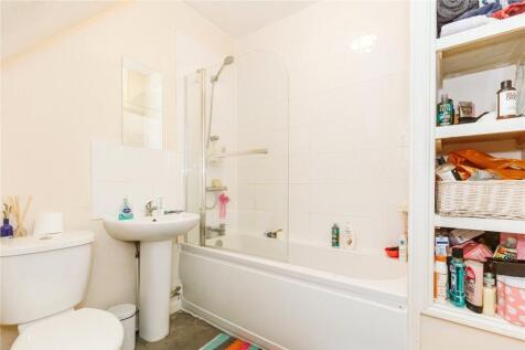 Bright and clean bathroom suite featuring a mod...