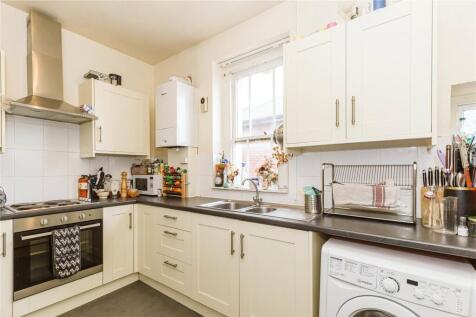 Bright and modern kitchen featuring ample cabin...