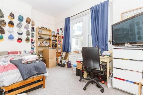 Bright and cozy bedroom featuring a comfortable...