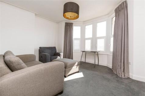 A bright and inviting living room featuring a c...