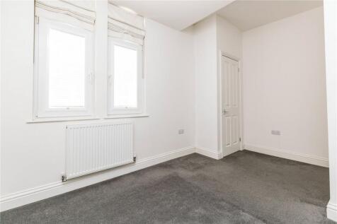 Bright and clean small room with white walls an...