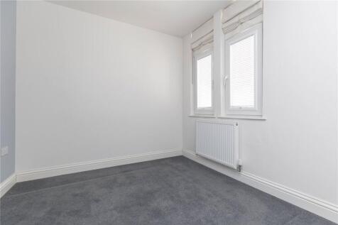 A clean, empty room with fresh white walls and ...