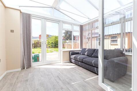 Bright and airy living room featuring ample nat...