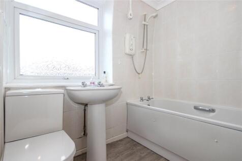 A bright and clean bathroom featuring a large f...