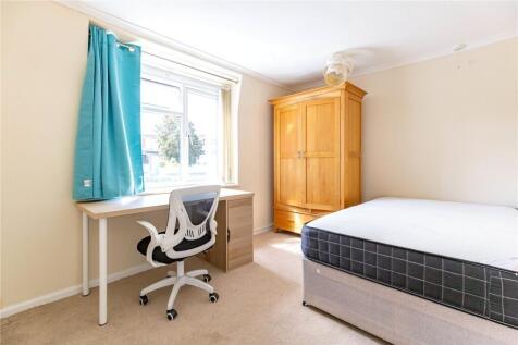 Bright and tidy bedroom featuring a comfortable...