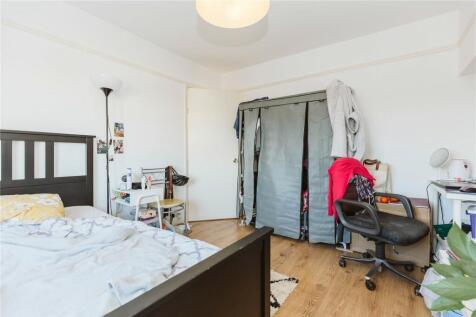 Bright and welcoming master bedroom featuring a...