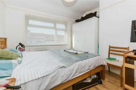 A bright and tidy double bedroom featuring a la...
