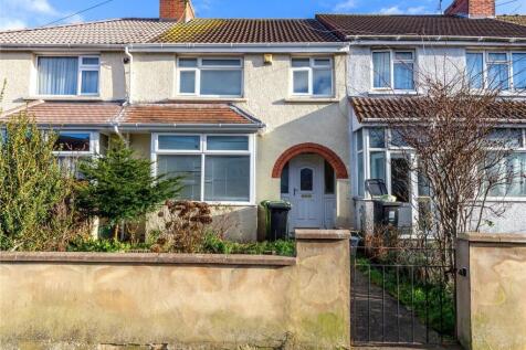 Charming terraced house front with a neat garde...