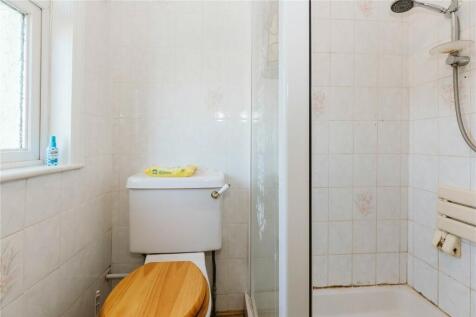 Bright bathroom featuring a shower cubicle and ...