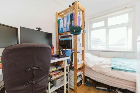 A bright single bedroom featuring a comfortable...