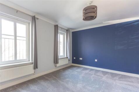 A bright and tidy double bedroom featuring larg...