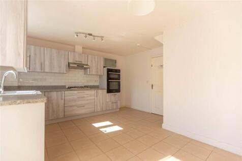 Bright and modern kitchen featuring tiled floor...