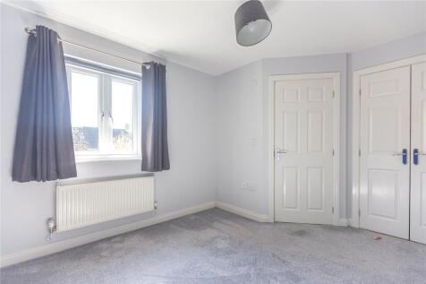 A bright and clean double bedroom featuring a l...
